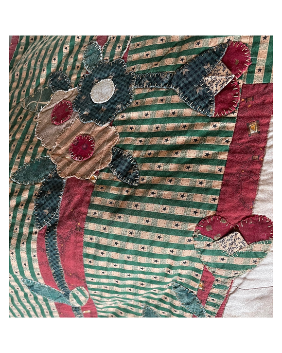 Patchwork quilt with floral applique patterns and striped design