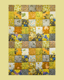 Patchwork quilt with floral patterns on a yellow background