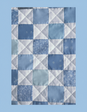 Patchwork quilt with a geometric pattern on a light blue background