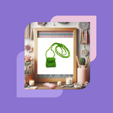 A hand holding a small, beaded bag necklace with green beads against a background with free spirit décor. 