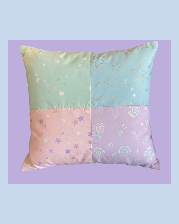 Patchwork dreamy time baby pillow with star and swirl patterns on a light purple background