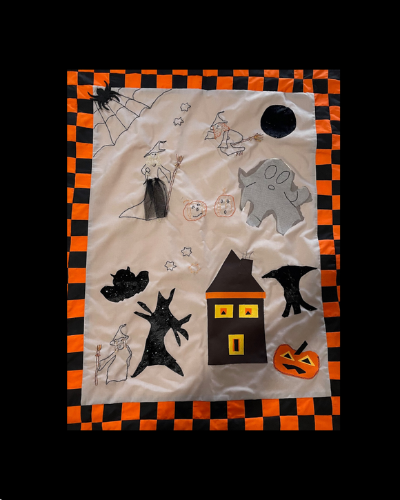 Halloween wall hanging why not make your own !!Halloween-themed decorative item with ghosts, pumpkins, and a house on a checkered border.