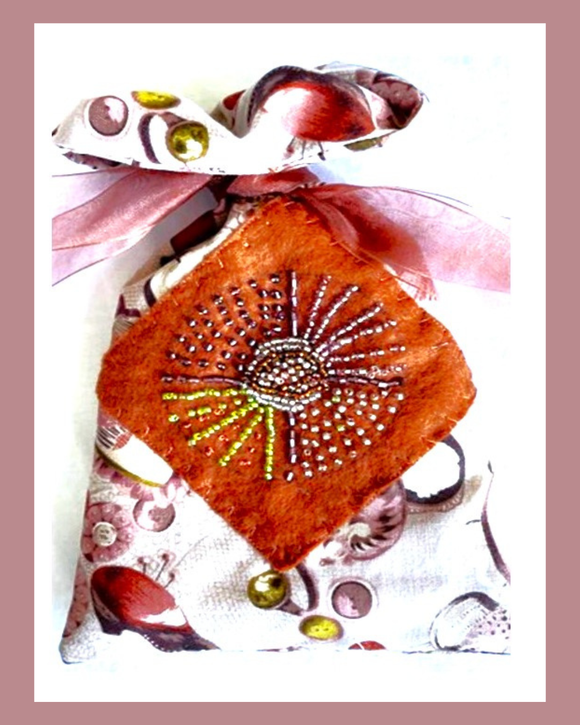Decorative pouch with floral patterns and bead embellishments on a white background