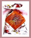 Decorative pouch with floral patterns and bead embellishments on a white background