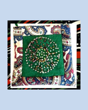 Decorative purse with green beadwork on a colourful paisley-patterned background