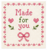 Cross-stitched design with 'Made for you' text and heart shapes on a white background.