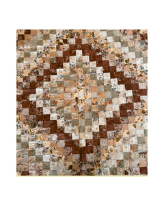Patchwork quilt with multi-coloured square patterns on a white background