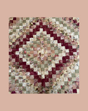 Patchwork quilt with floral patterns on a pink background