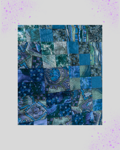 Patchwork quilt with blue and green patterns on a light purple background