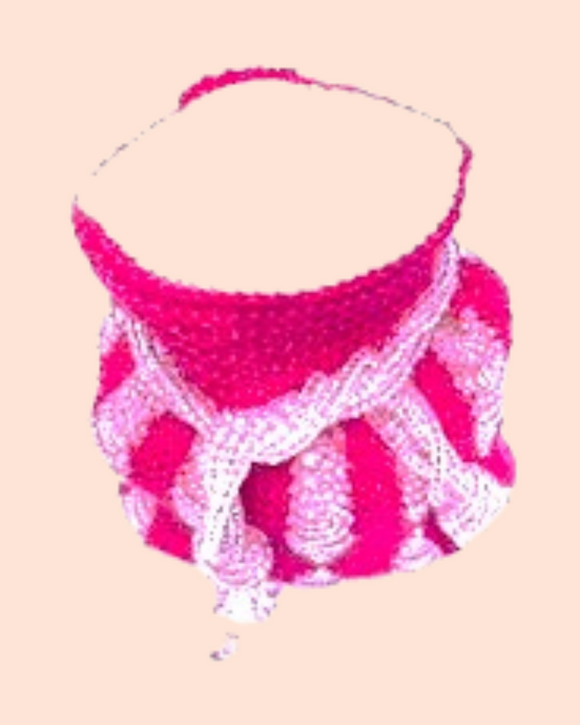 Pink and clear beads knitted into a  beaded pouch on a pastel background