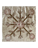 Decorative quilt with floral  applique pattern on a white background