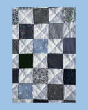 Patchwork quilt with a geometric pattern on a blue background