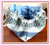 Fabric bag with blue and white pattern on a wooden surface