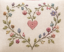 Embroidered heart design with flowers on fabric