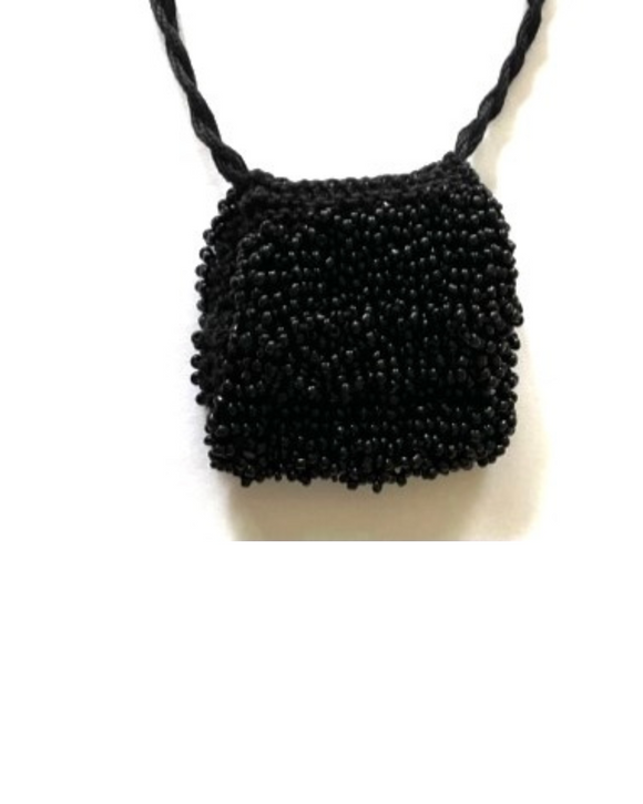 black beaded bag hanging on a white background