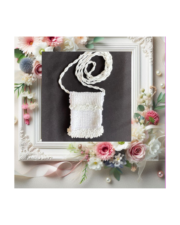 White designer bead knitted necklace on a dark background with floral wedding decorations