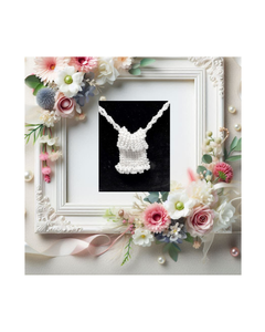 Framed wedding display with beaded white necklace and floral decoration