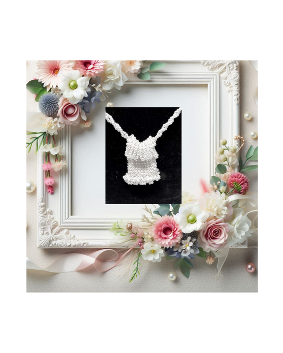 Framed wedding display with beaded white necklace and floral decoration