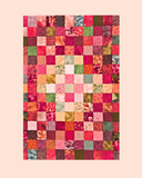 Patchwork quilt with multicolored squares on a beige background