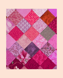 Patchwork quilt with pink and red squares on a beige background