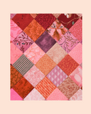 Patchwork quilt with a variety of colourful squares on a pastel background
