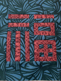 Fabric square with red geometric pattern on a blue leafy background