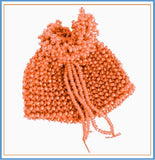 A handmade orange beaded pouch with a drawstring closure.
